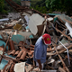 On Jan. 26, 2019, man stands in the debris of his home, which was destroyed after a dam collapsed in Brumadinho, Brazil a day earlier.